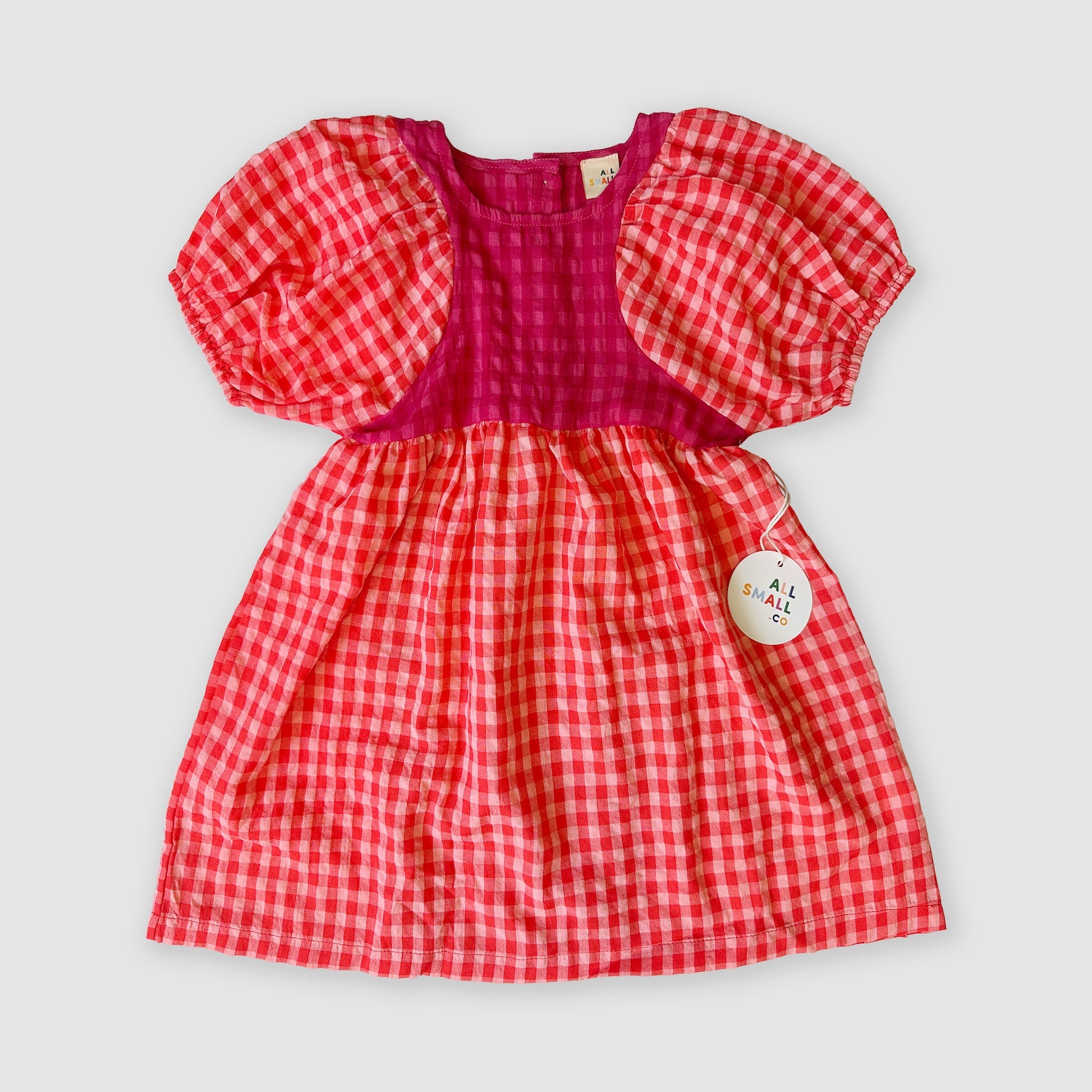Red and white checkered dress with puff sleeves on a light gray background